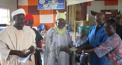 Handing over reading and writing materials to the community of Kanam