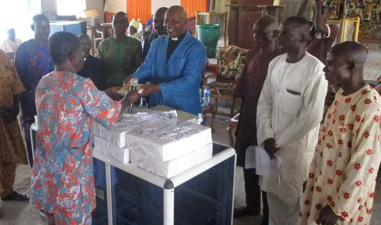 Handing over reading and writing materials to the church